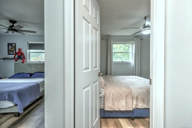 bedroom with hardwood / wood-style flooring and ceiling fan