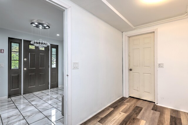 foyer featuring tile patterned floors and a chandelier