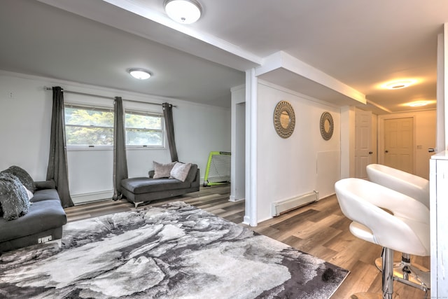 living room with a baseboard heating unit, hardwood / wood-style flooring, and ornamental molding