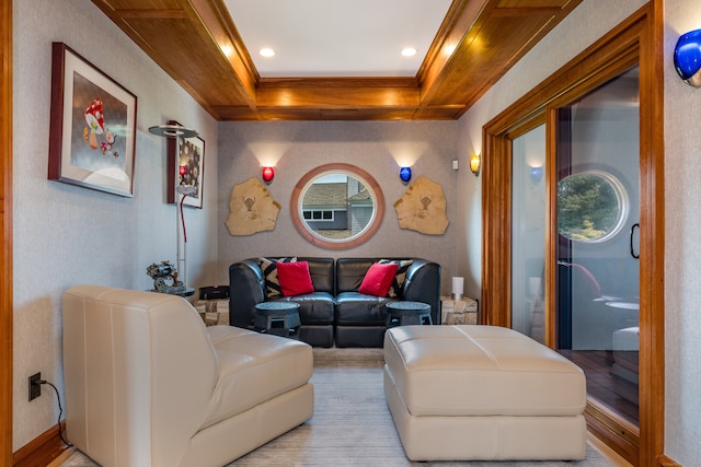 living room featuring light wood-type flooring, a raised ceiling, and ornamental molding