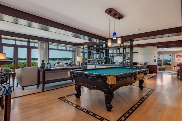 game room with beamed ceiling, billiards, a water view, and light hardwood / wood-style flooring