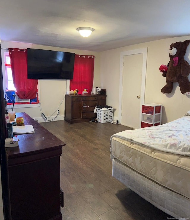 bedroom with dark wood-type flooring