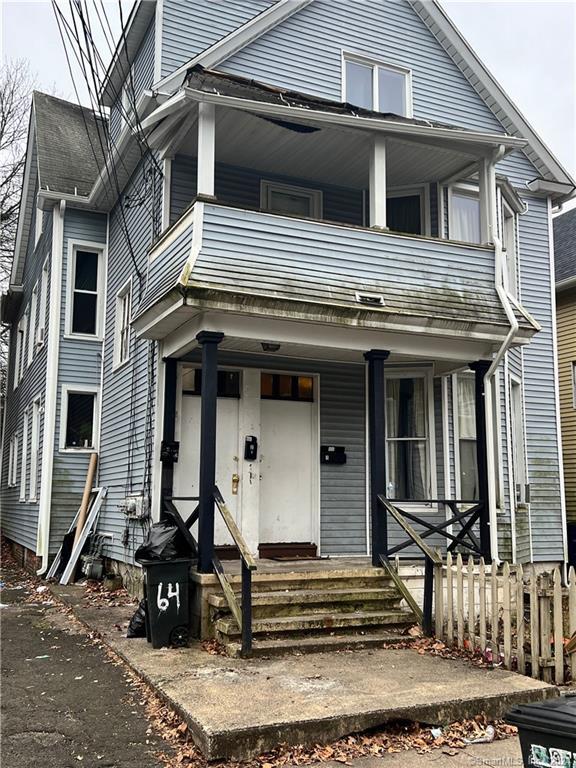 view of front of house with a balcony and a porch