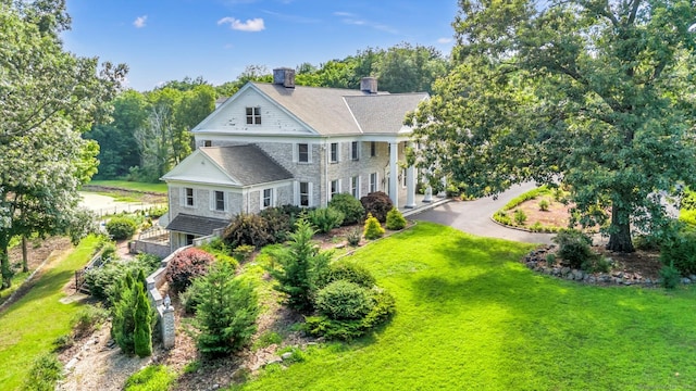 rear view of house featuring a lawn