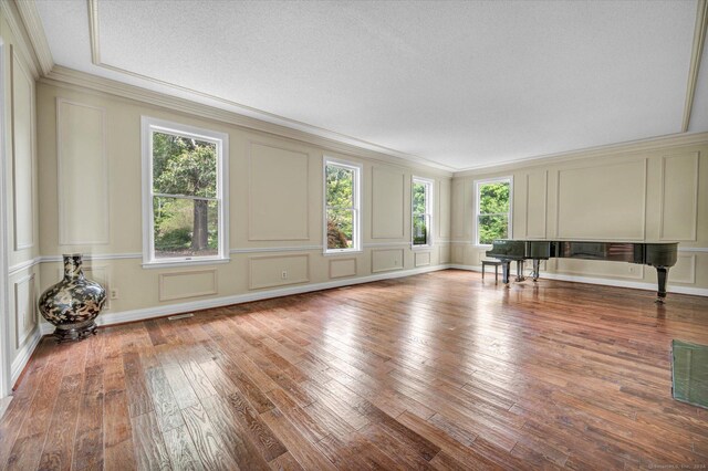 interior space with crown molding, light hardwood / wood-style flooring, and a textured ceiling