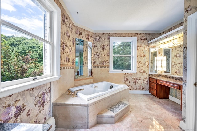 bathroom featuring tiled tub, vanity, tile patterned flooring, and crown molding