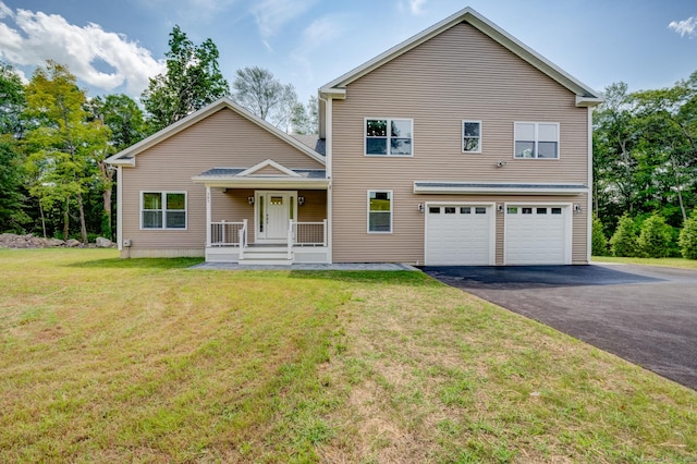 view of property featuring a front yard and a garage