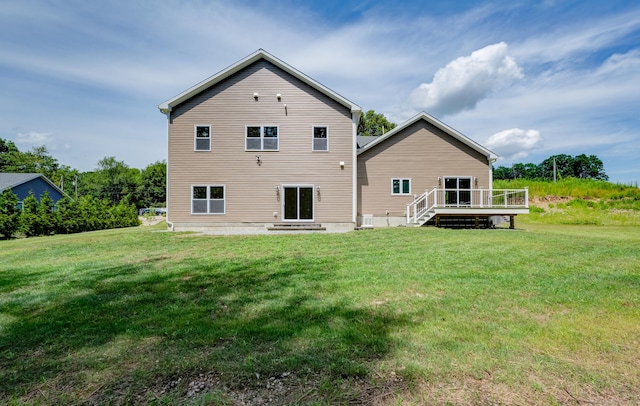 back of house with central air condition unit, a wooden deck, and a yard