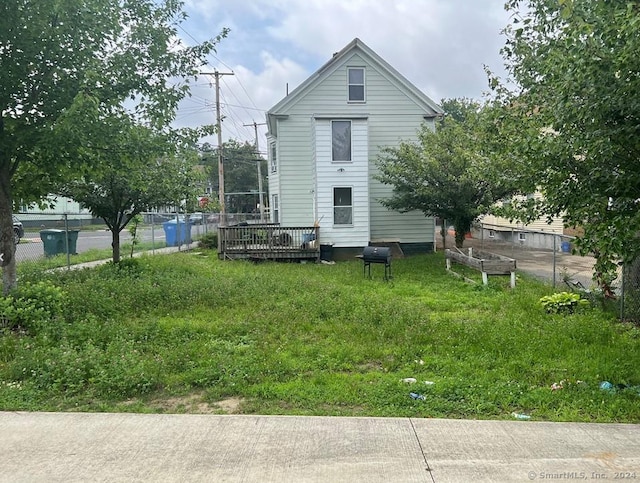 exterior space featuring a wooden deck and a yard