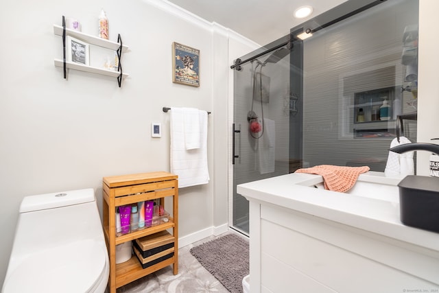 bathroom with ornamental molding, vanity, a shower with shower door, and toilet