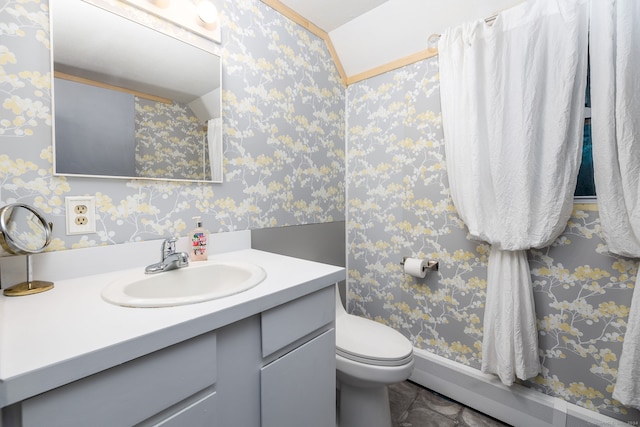 bathroom with vanity, baseboard heating, and toilet