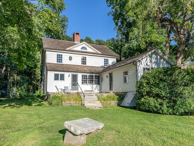 back of house featuring a yard