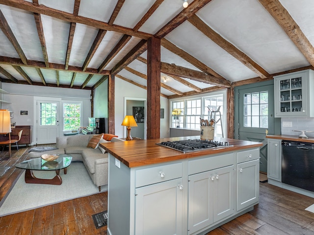 kitchen featuring dishwasher, stainless steel gas stovetop, white cabinetry, butcher block counters, and vaulted ceiling with beams