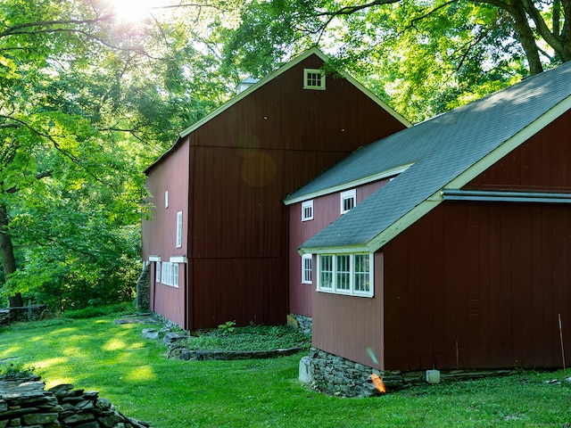 view of property exterior featuring a yard and an outbuilding