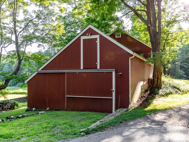 view of outbuilding featuring a lawn