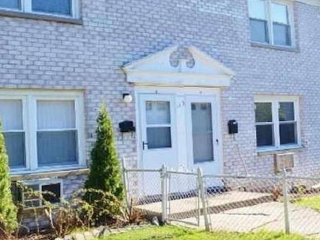 doorway to property featuring a yard