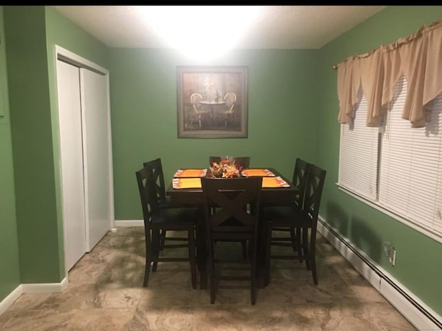 dining area with a baseboard radiator