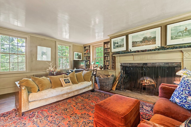 living room with a healthy amount of sunlight, crown molding, and wood-type flooring