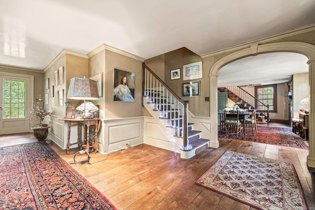 foyer with crown molding and hardwood / wood-style flooring