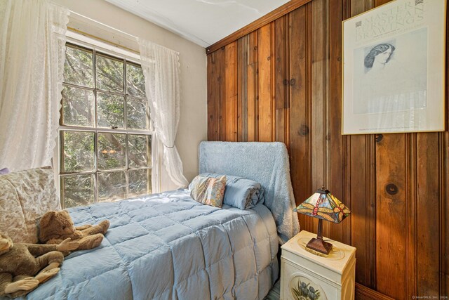 bedroom with wooden walls