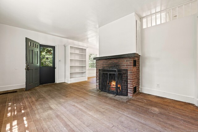 unfurnished living room with a fireplace and hardwood / wood-style flooring