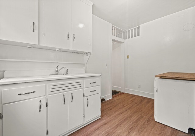 kitchen featuring white cabinets and light wood-type flooring