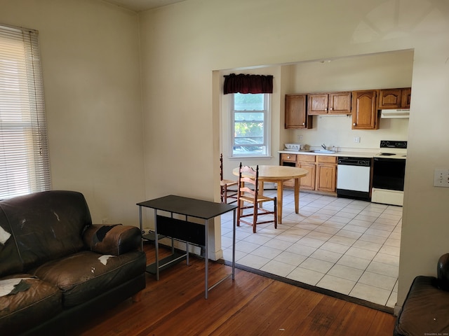 kitchen with white appliances, light hardwood / wood-style floors, and sink