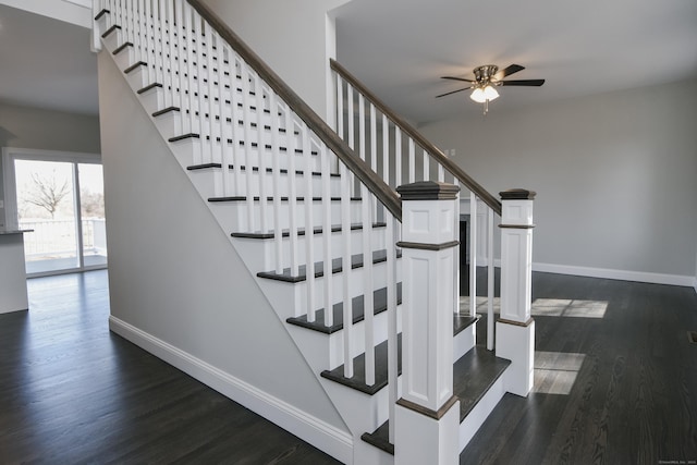 stairway with ceiling fan, baseboards, and wood finished floors