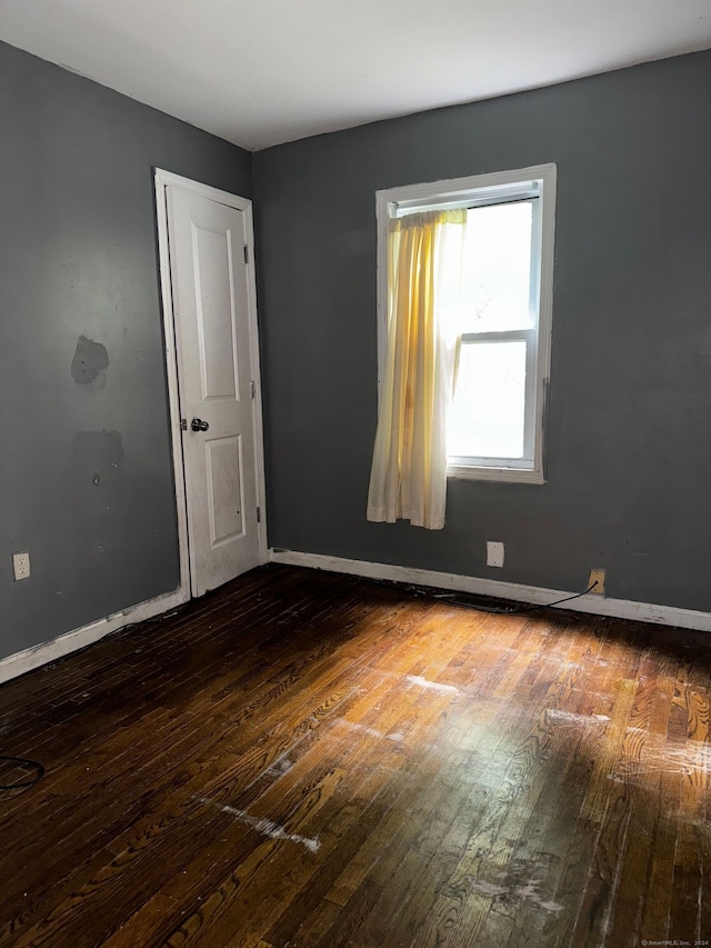 unfurnished room with hardwood / wood-style floors