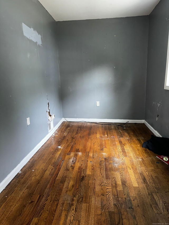 unfurnished room with hardwood / wood-style flooring