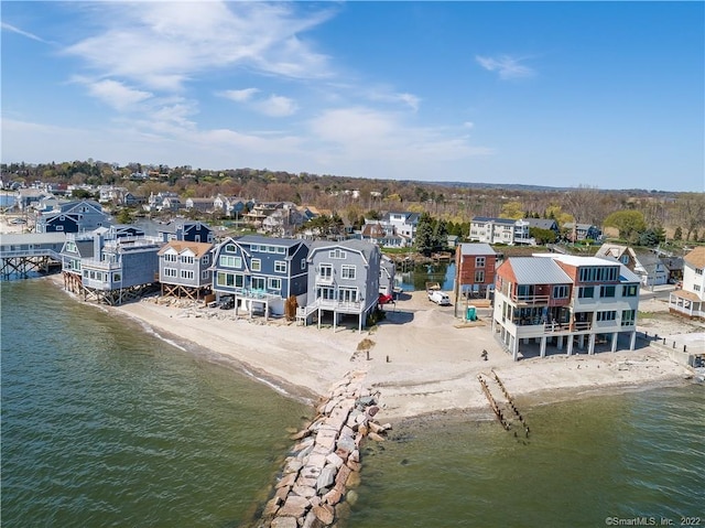 aerial view featuring a residential view, a water view, and a view of the beach