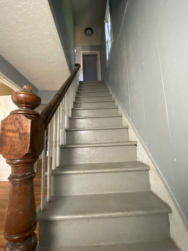 stairway with wood walls