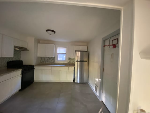 kitchen with decorative backsplash, range hood, black range with electric cooktop, stainless steel fridge, and white cabinetry