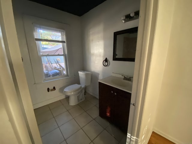 bathroom featuring vanity, toilet, and tile patterned floors