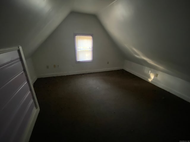 additional living space featuring lofted ceiling