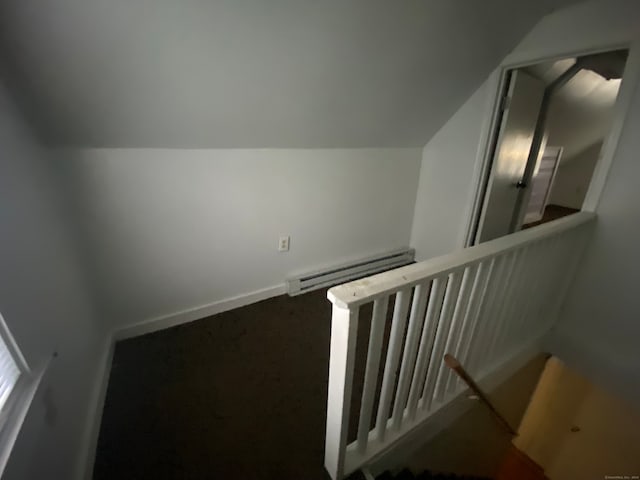 staircase with baseboard heating, lofted ceiling, and carpet flooring