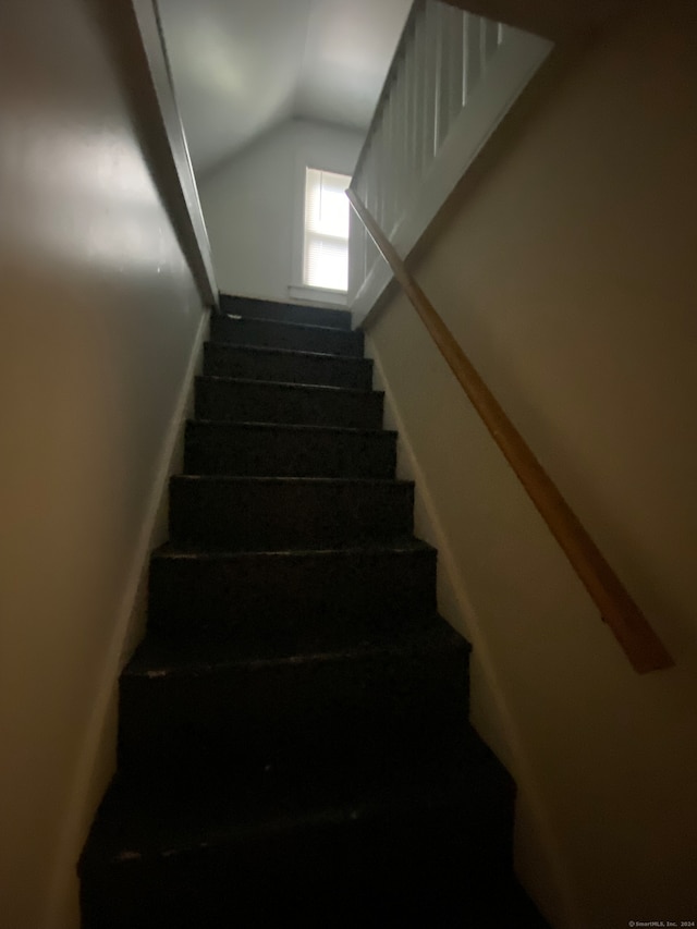 stairs with lofted ceiling