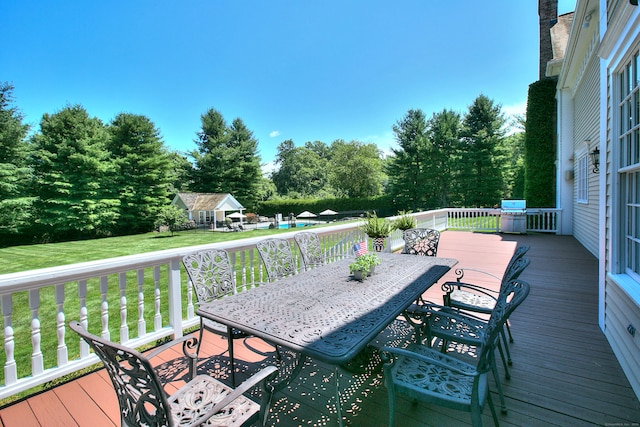 wooden terrace with a lawn