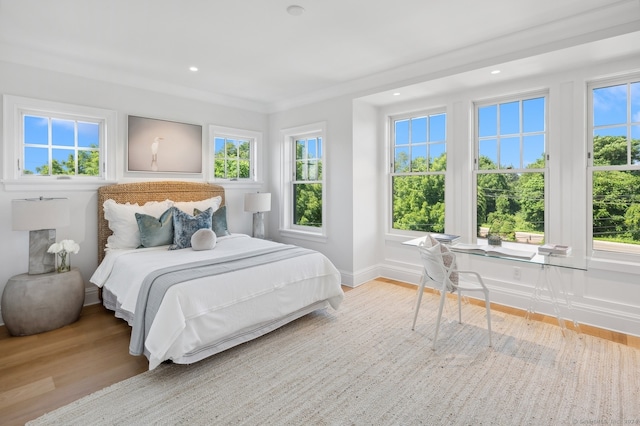 bedroom featuring light hardwood / wood-style flooring and ornamental molding