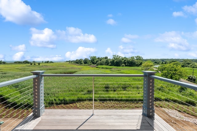 wooden deck with a rural view