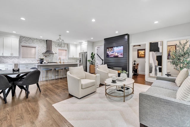 living area with light wood finished floors and recessed lighting