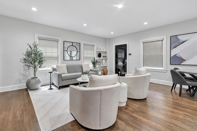 living area with recessed lighting, dark wood-style flooring, and baseboards