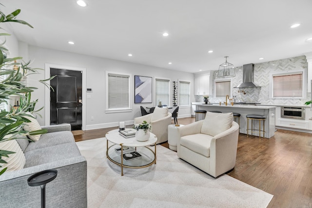 living room featuring recessed lighting, baseboards, and wood finished floors