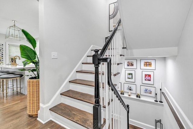 stairway featuring baseboards and wood finished floors