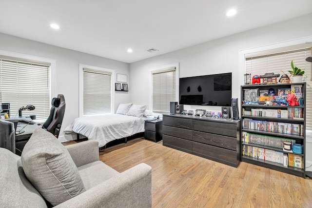 bedroom featuring wood finished floors, visible vents, and recessed lighting