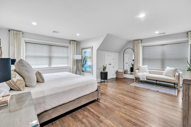 bedroom with visible vents, wood finished floors, and recessed lighting