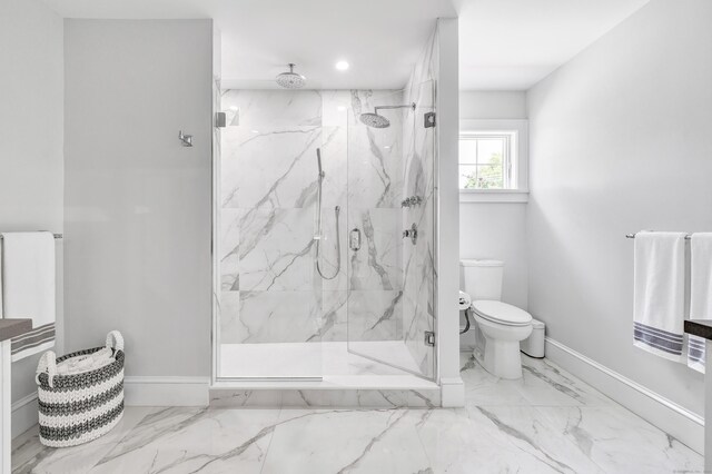 bathroom with marble finish floor, baseboards, toilet, and a marble finish shower