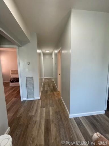 corridor featuring dark hardwood / wood-style floors