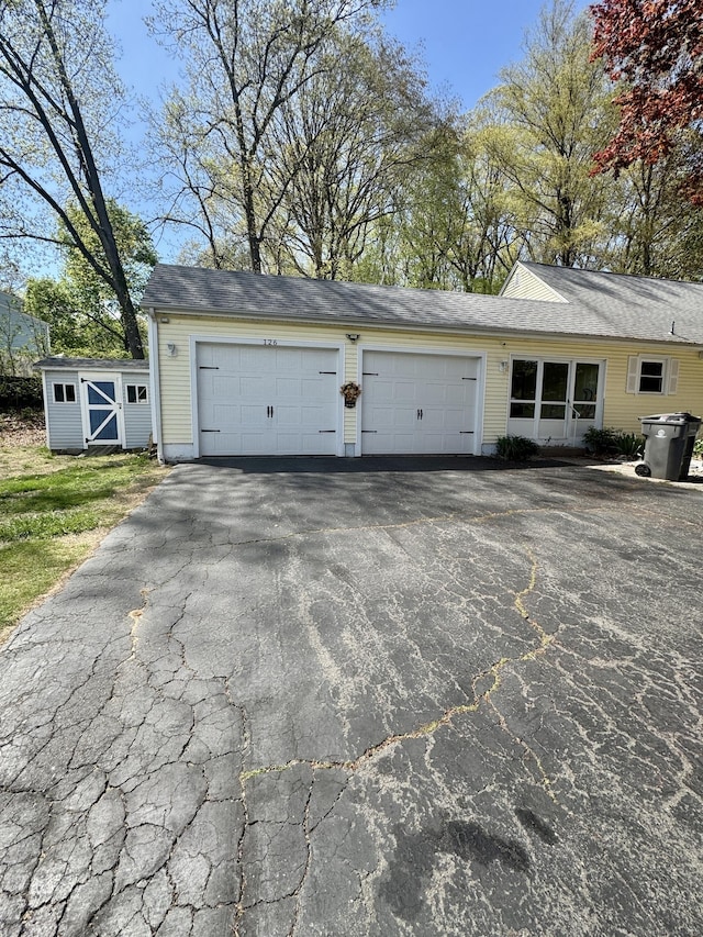 garage with aphalt driveway