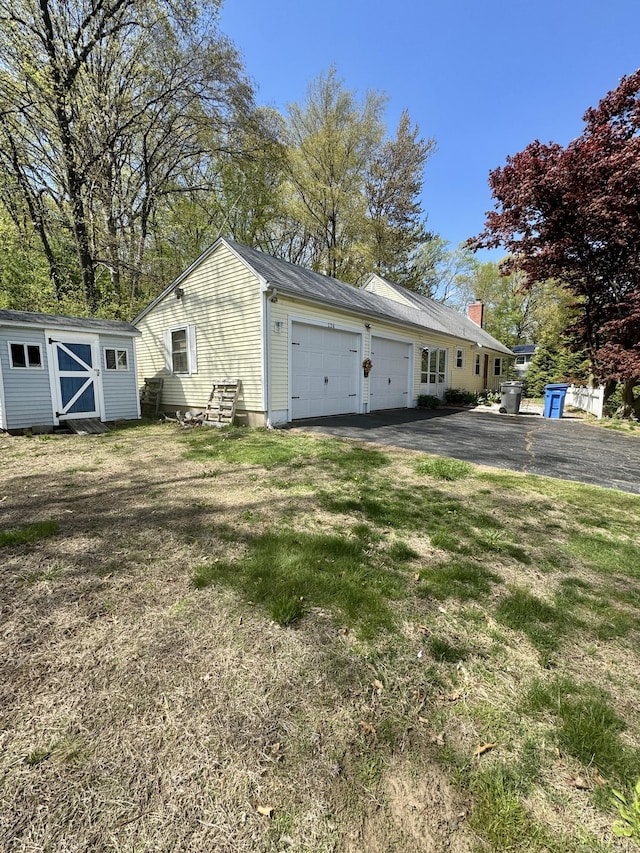 exterior space featuring a storage shed and driveway